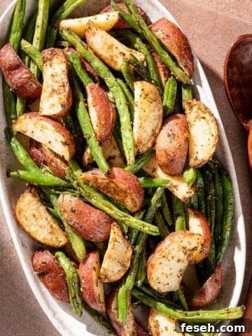 potatoes and green beans on platter with serving spoon on the side