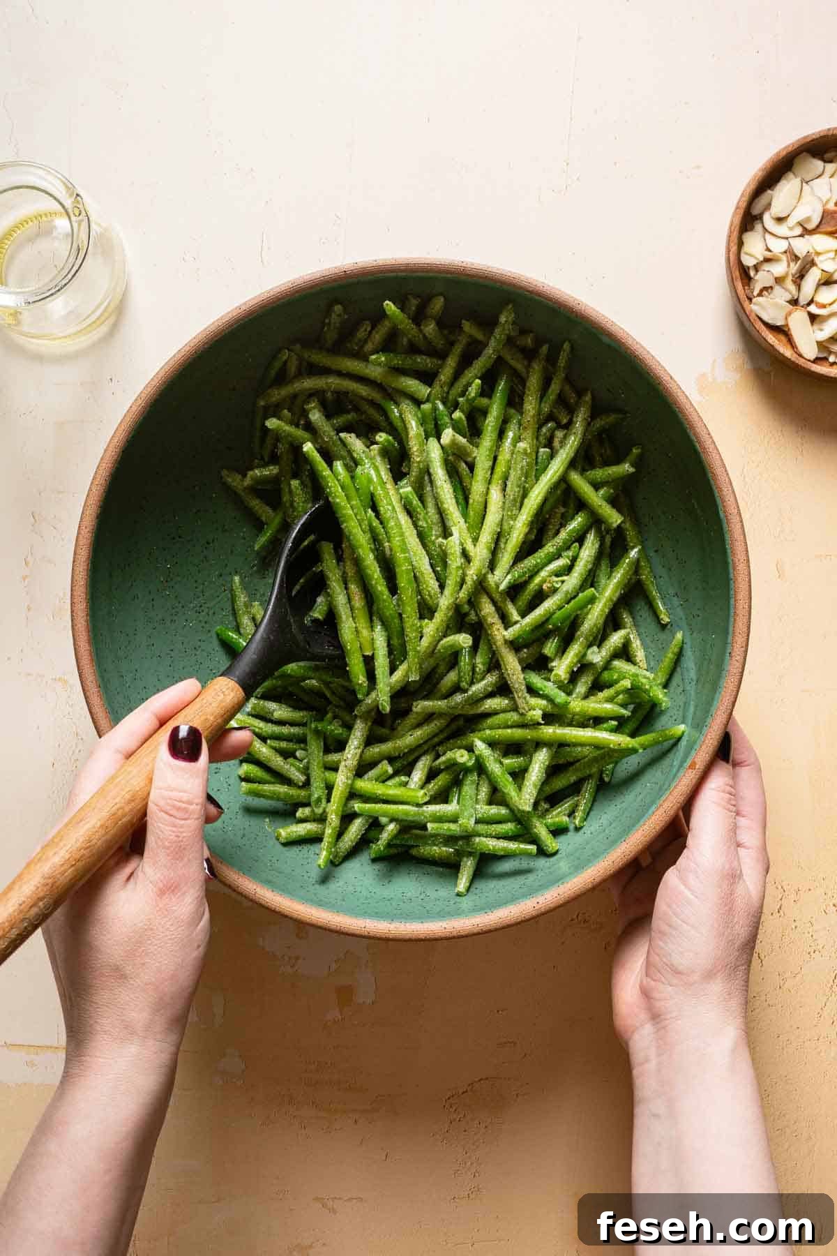 frozen green beans being stirred with wooden spoon.