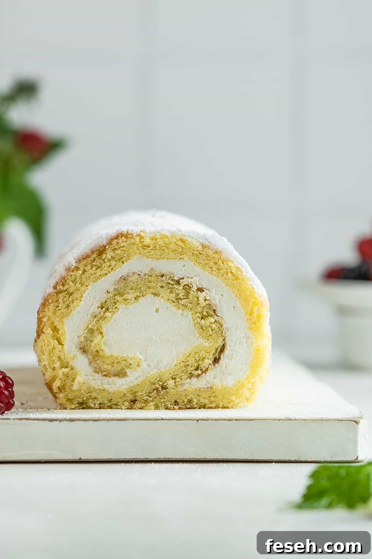 Assembled sponge cake roll on a serving platter.