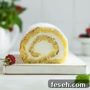 Vanilla sponge cake roll on a serving board.