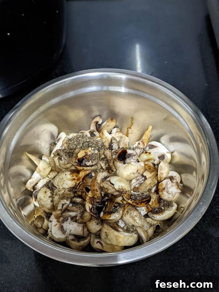 Sliced button mushrooms with soy sauce, pepper, minced garlic and olive oil for marinating