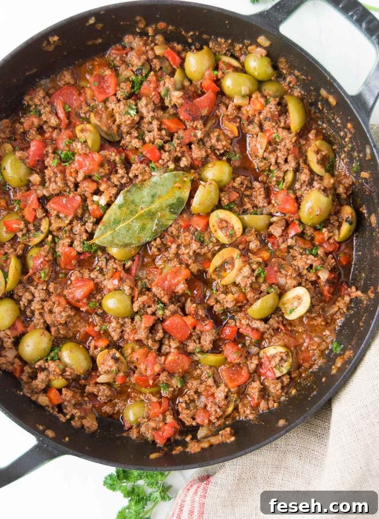 Close up of Brazilian picadillo recipe in a black braiser from above