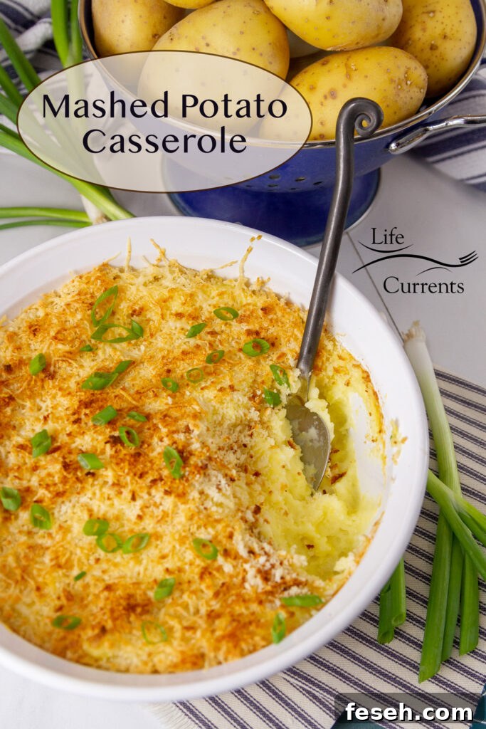 Mashed Potato Casserole with a serving taken out of it and some potatoes behind it.