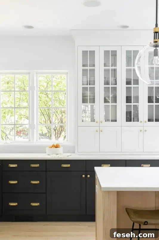 a black and white kitchen with wood island