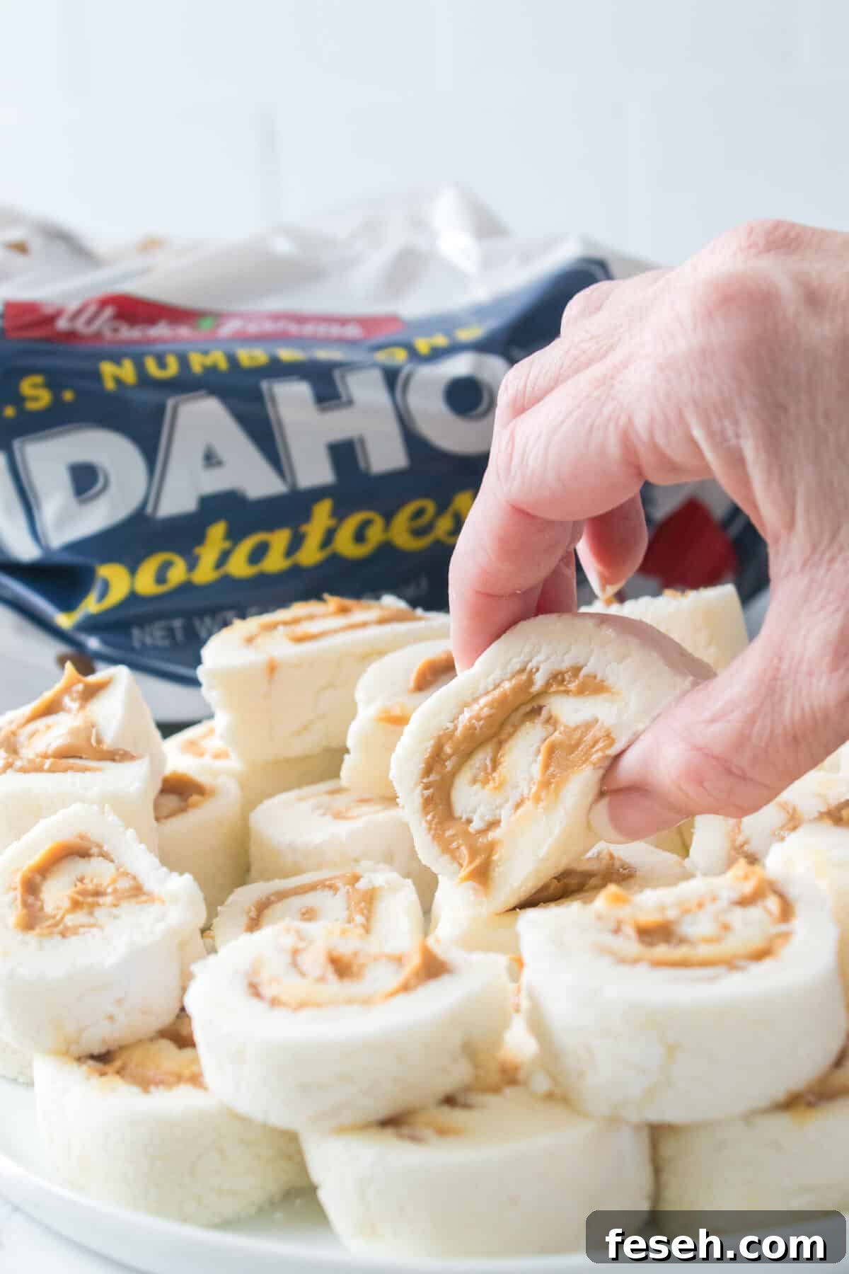 hand grabbing potato candy on a plate