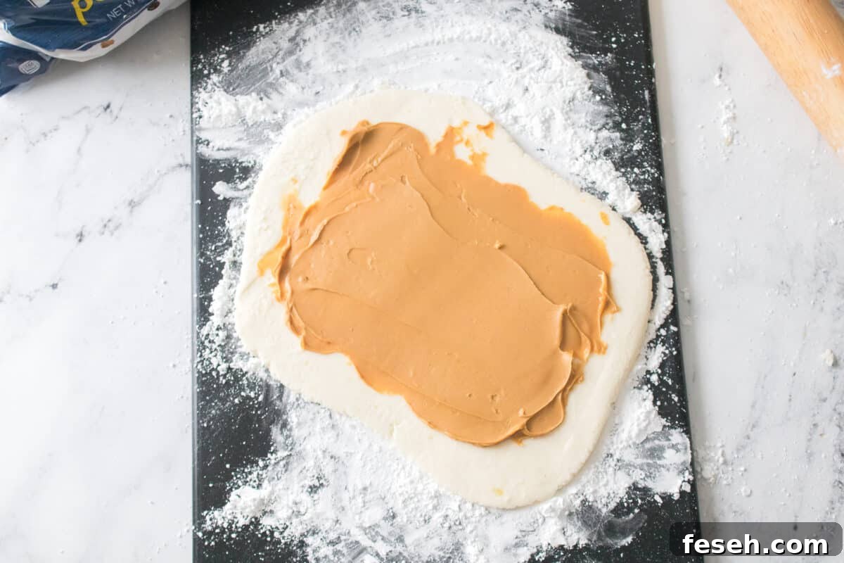 overhead shot of potato candy rolled out into a rectangle with peanut butter on top