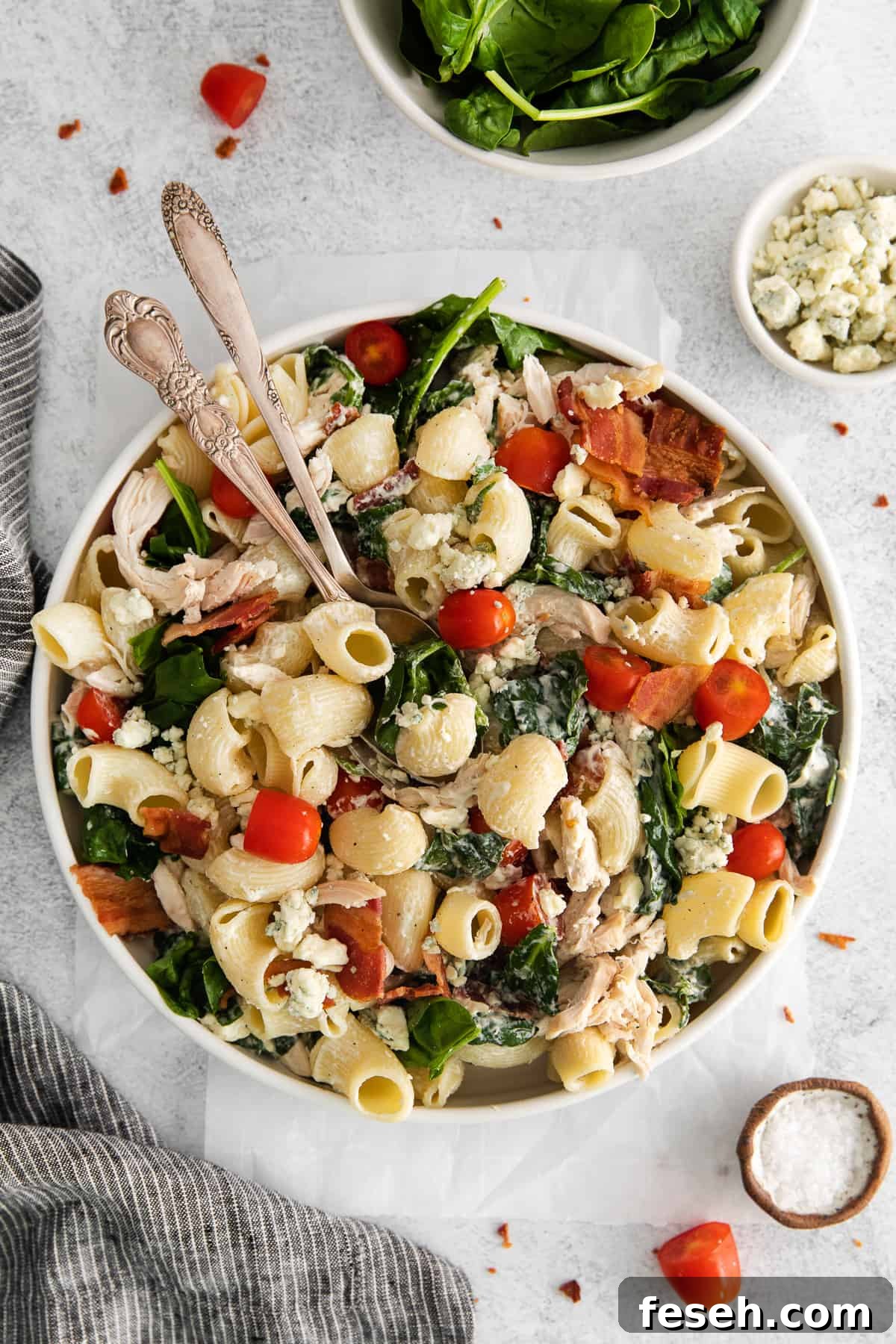 Gorgonzola chicken pasta salad in a bowl with spoons.