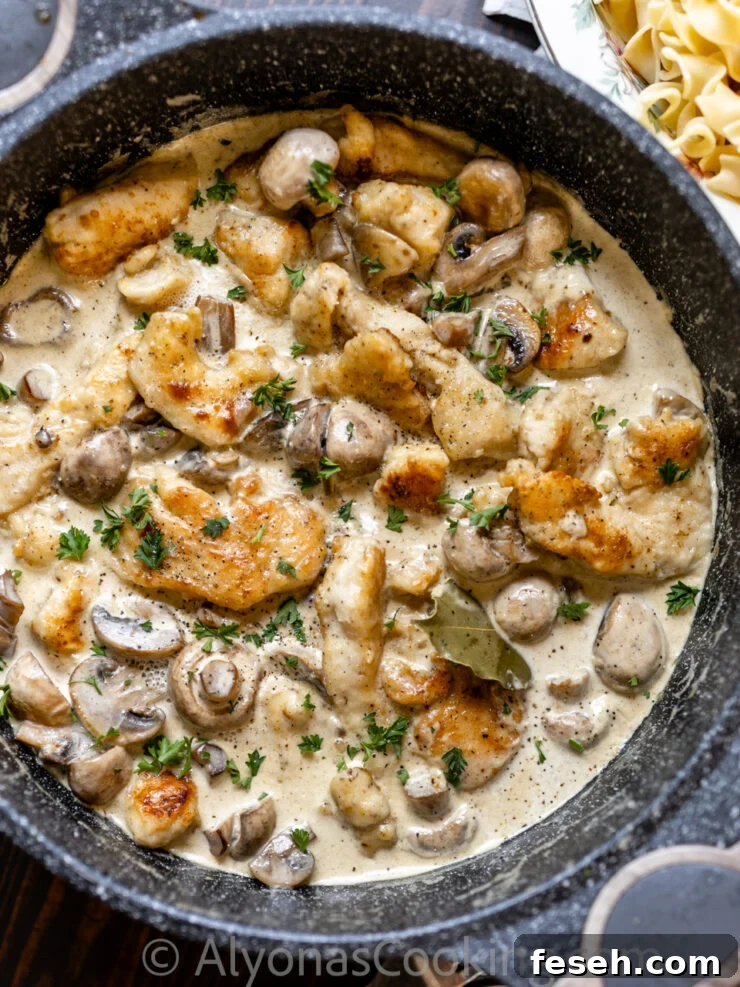 image of smothered chicken with a cream gravy, and whole mushrooms 