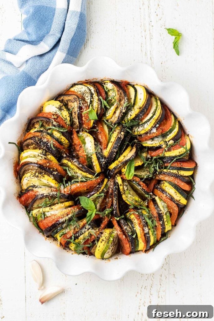 A baked ratatouille topped with parmesan and basil.