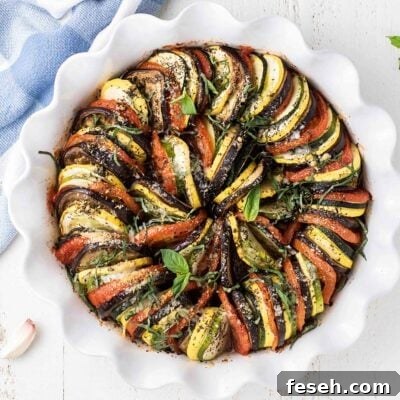 A baked ratatouille topped with parmesan and basil.