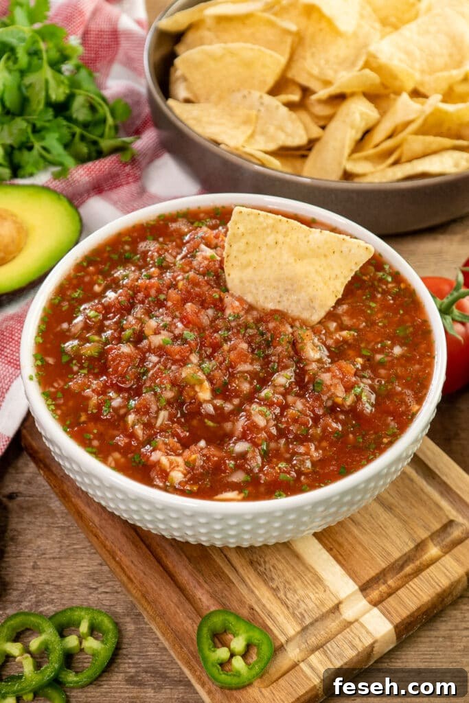 Close up of homemade salsa in a white bowl.