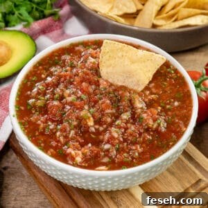 Close up of homemade salsa in a white bowl.