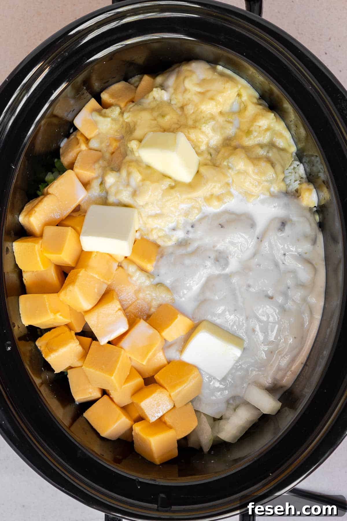 All of the ingredients except the shredded cheddar are added to the crock.