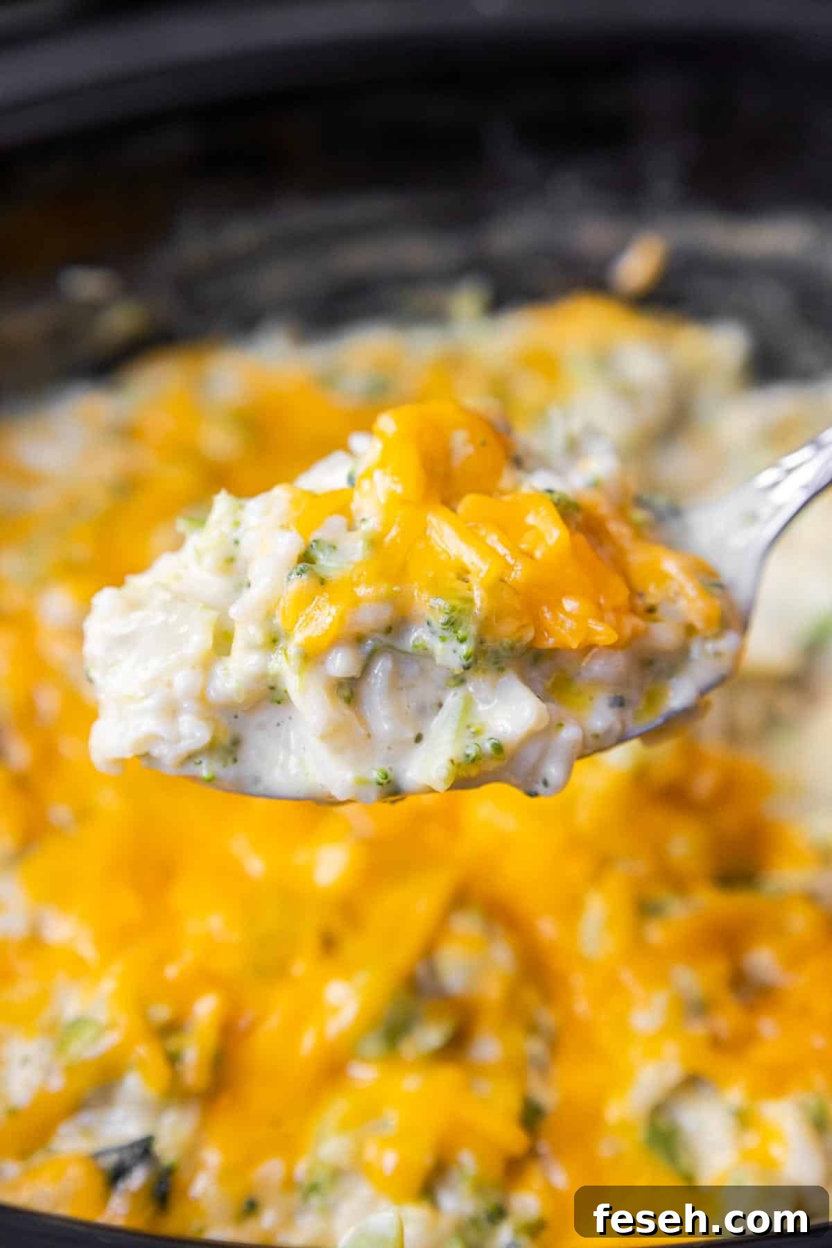 Spoonful of Crockpot Broccoli Rice Casserole to show the creamy consistency.