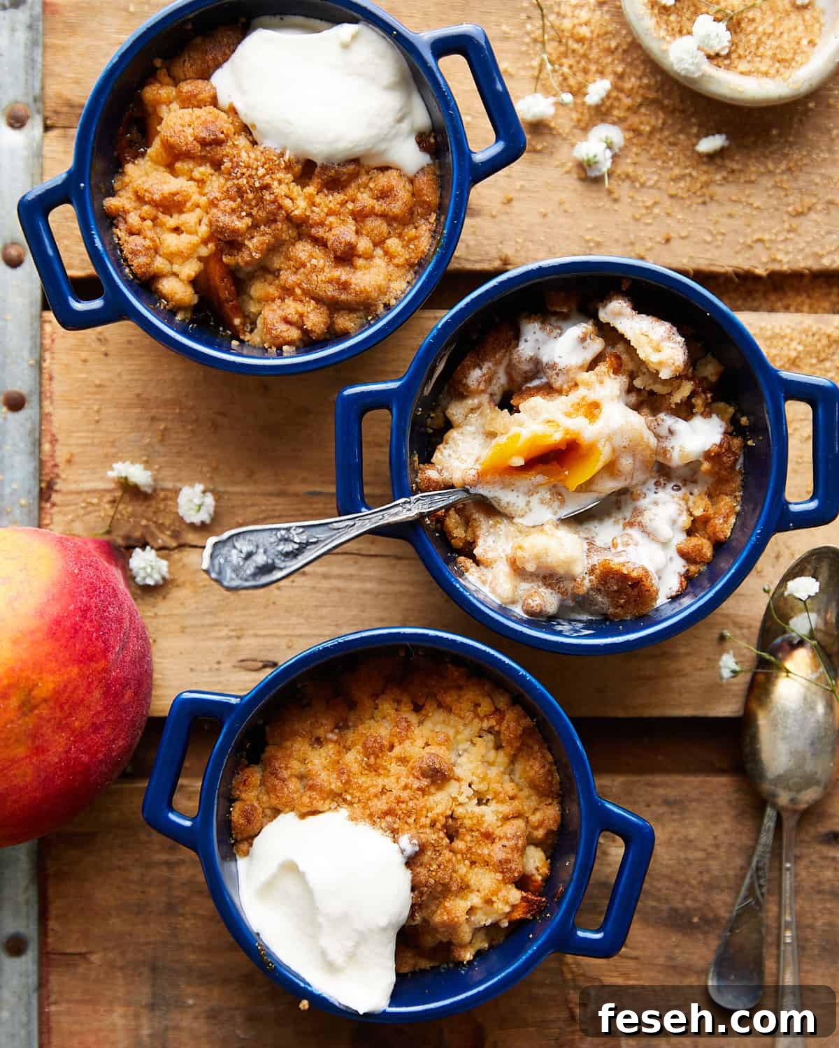 Air fryer peach cobbler with whipped cream on top.