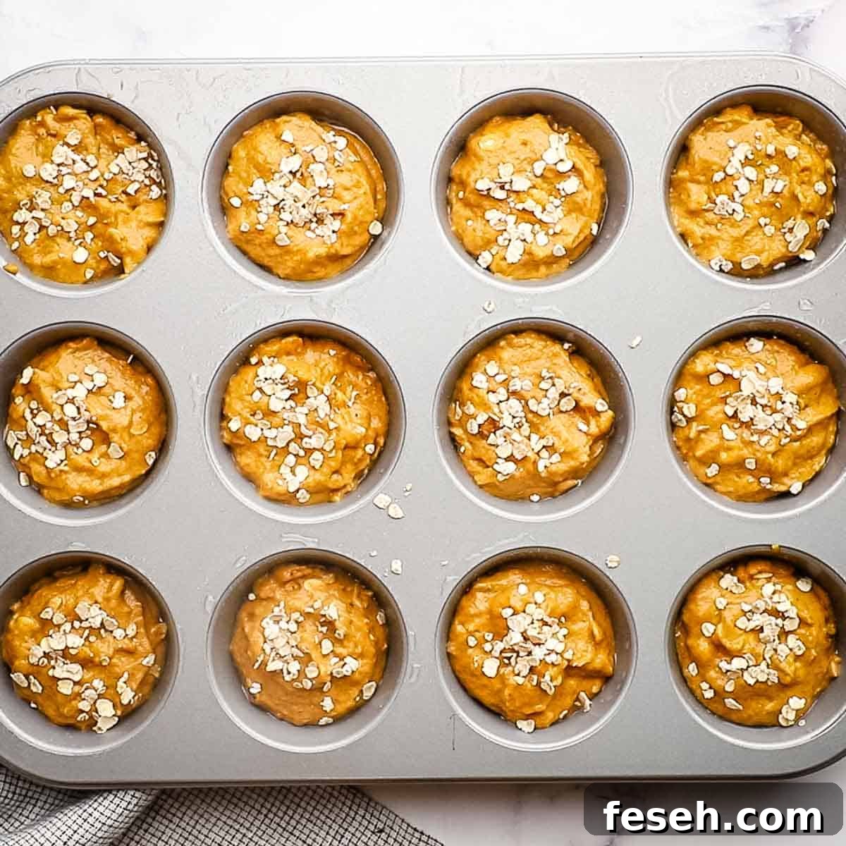 oatmeal muffin batter in a muffin tin
