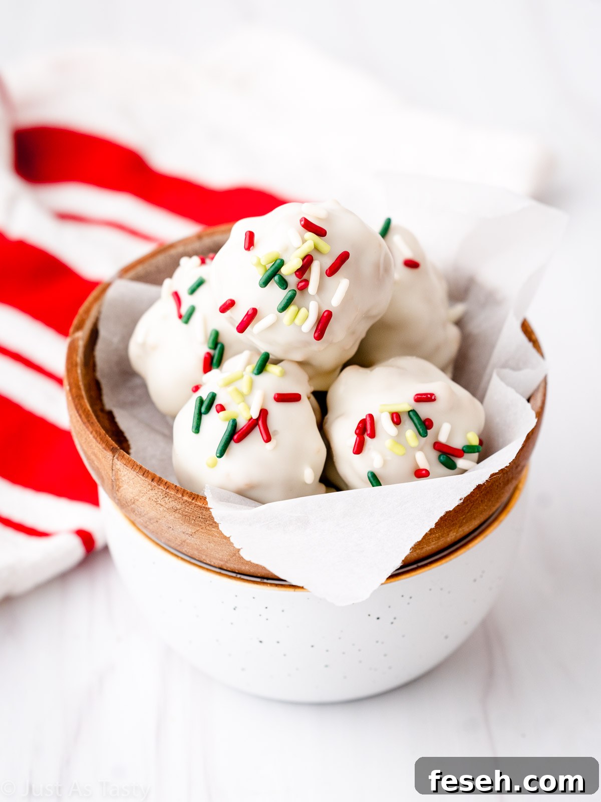 White chocolate-coated gingerbread truffles in a bowl.