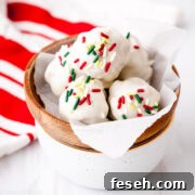 White chocolate-coated gingerbread truffles in a bowl.