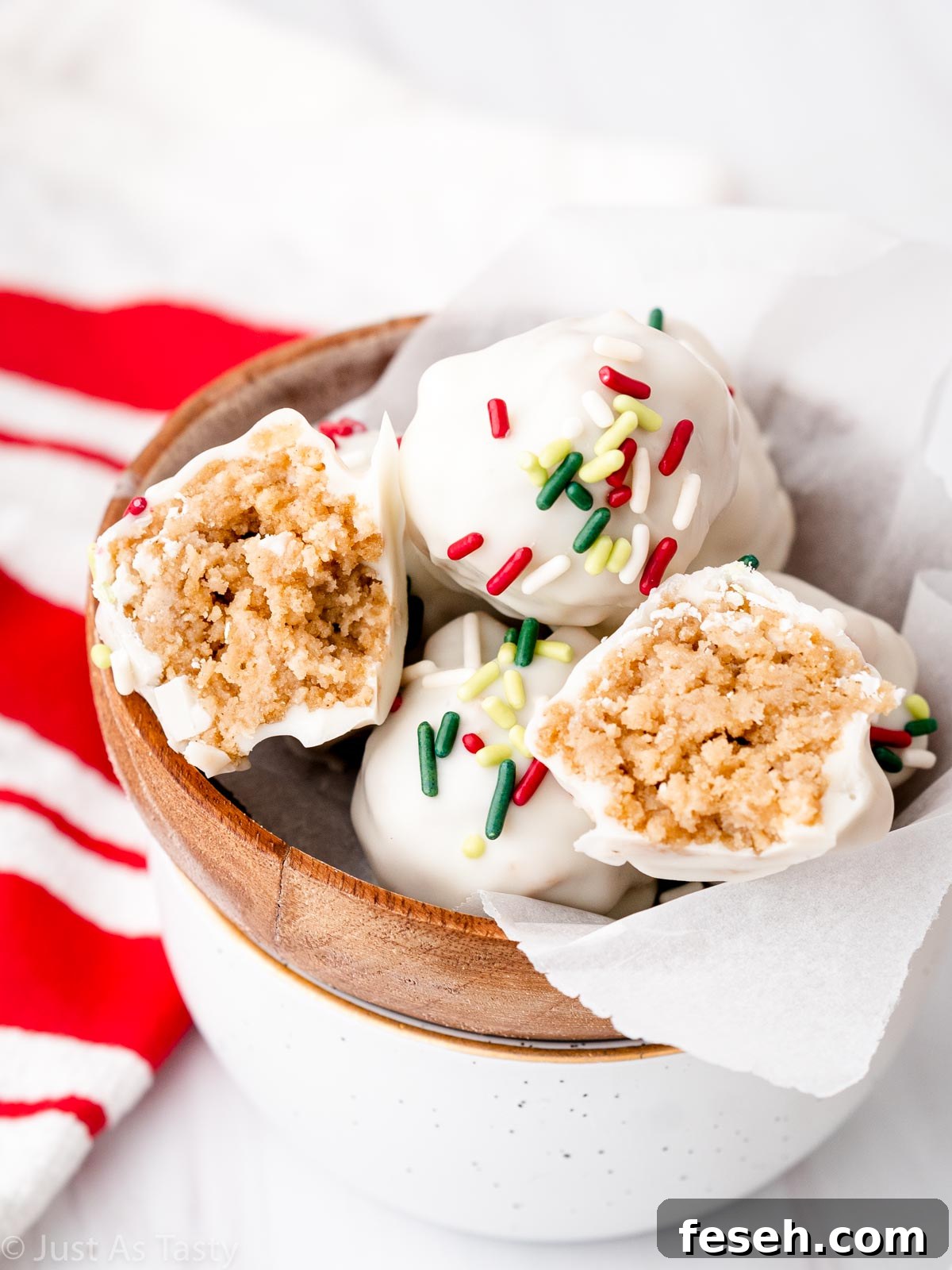 Gingerbread truffles in a bowl, with one cut in half revealing the inner texture.