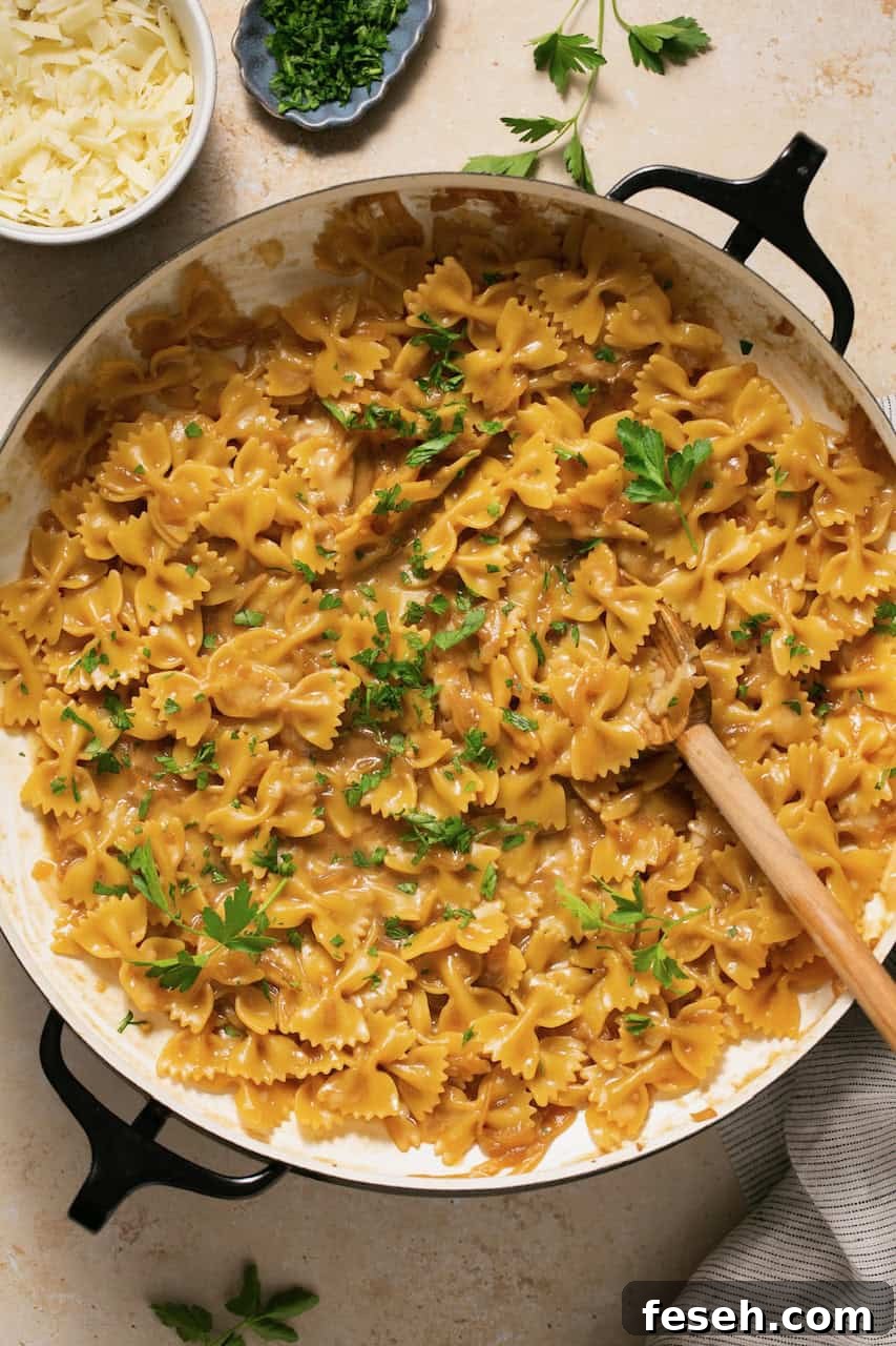 a pot of french onion pasta topped with fresh parsley