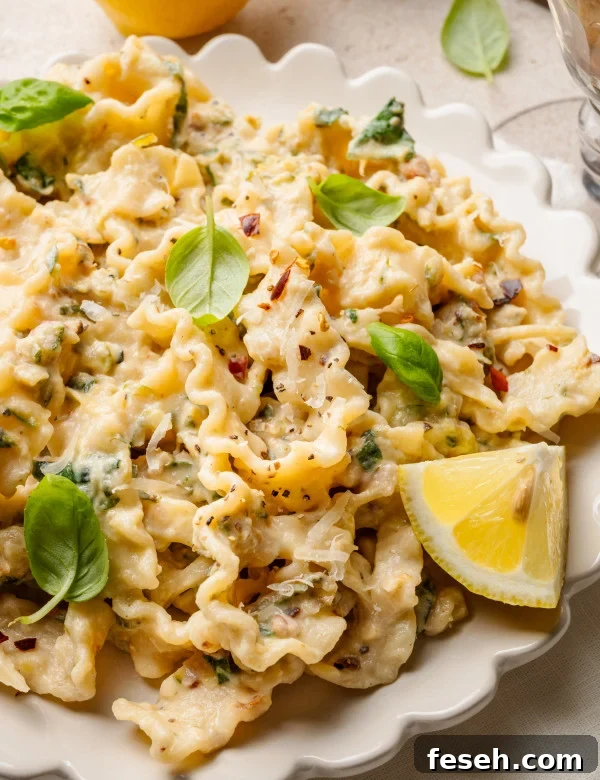 Zucchini lemon pasta garnished with fresh basil and lemon