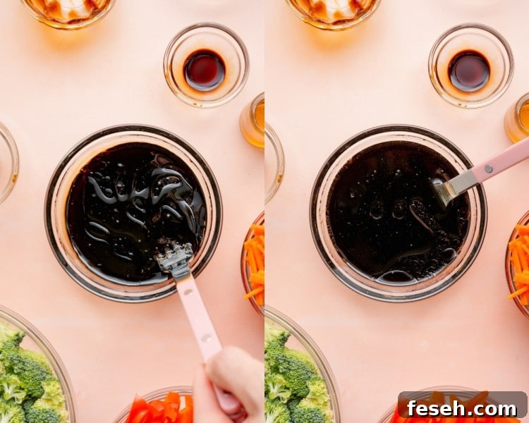 A dark sesame sauce being whisked until smooth and glossy.