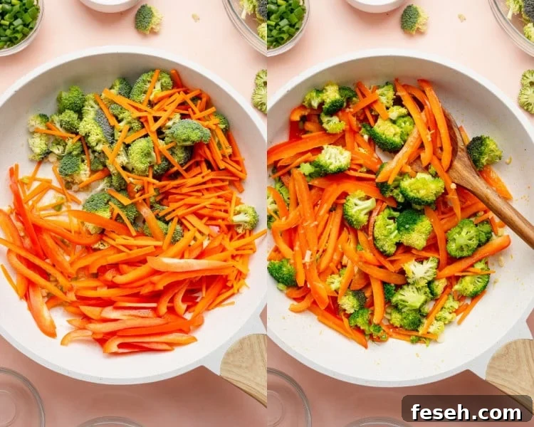Sliced red bell peppers, julienned carrots, and broccoli florets added to the skillet and sautéed until slightly tender.