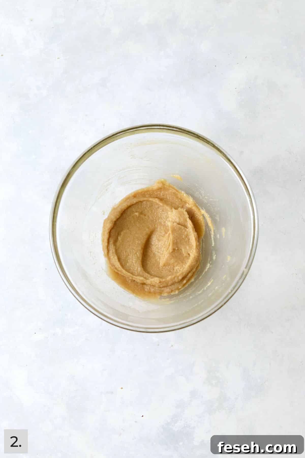 Butter, sugar, egg yolk, and vanilla creamed in a mixing bowl.