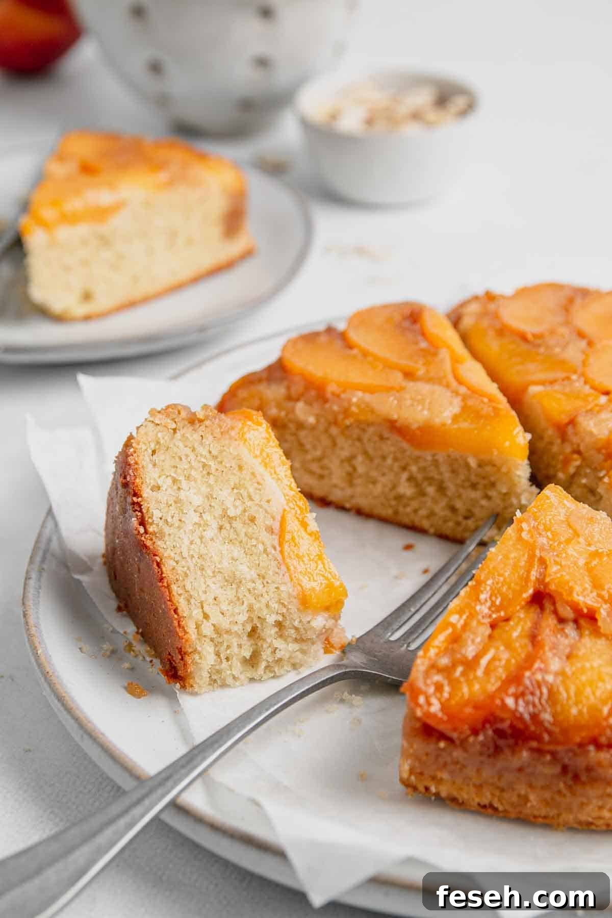 Gluten-free peach upside down cake sliced in triangles with one on its side.