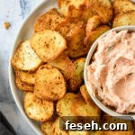 air fryer everything bagel chips on a plate with smoked salmon dip.