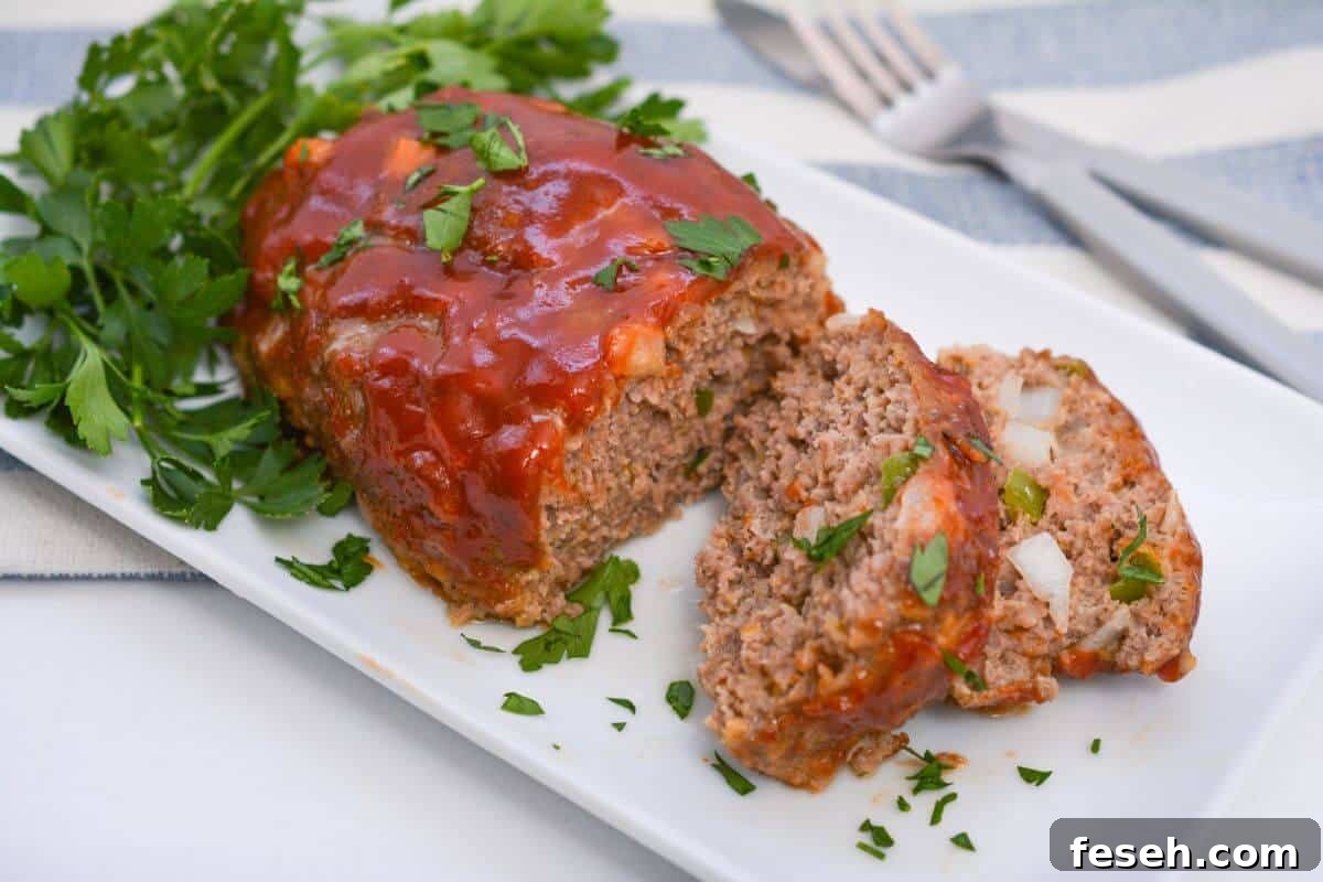 Meatloaf on a white platter with a fork.