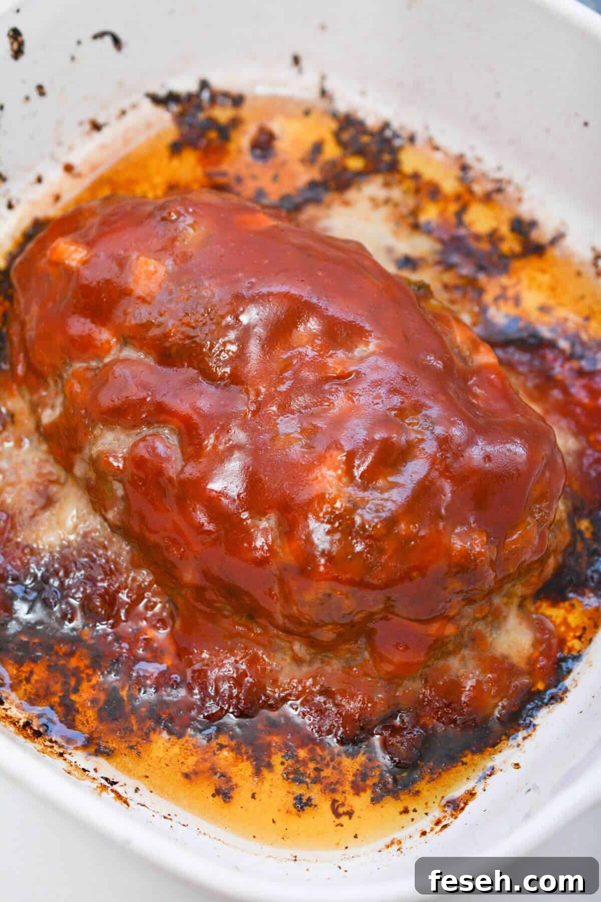 Meatloaf in a baking dish with sauce.