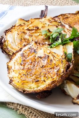 Easy roasted cabbage basted with garlic paste and either fennel or caraway seeds for a super-easy side dish. They take 10 - 15 minutes of prep, and only 4 ingredients (+ salt and pepper). #RoastedCabbage #HealthyRecipes #LowCarb #CleanEating #RoastedCabbageWedges #RoastedVegetables #VegetarianRecipes #VeganRecipes #Recipe #Recipes #CabbageSteaks #TheWimpyVegetarian