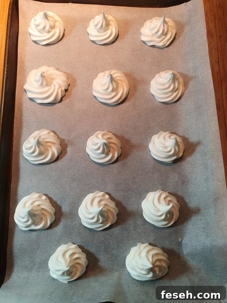 Meringues on baking tray ready to bake