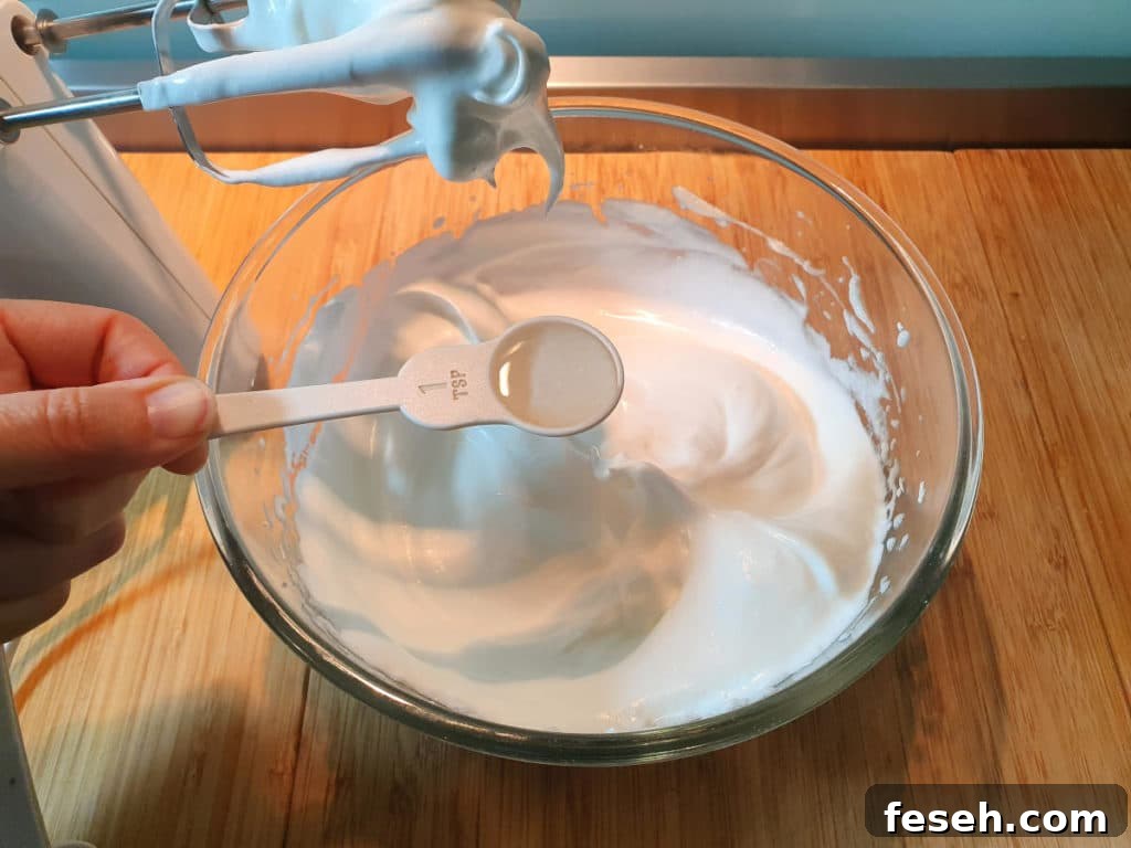 Adding vinegar to meringue mix