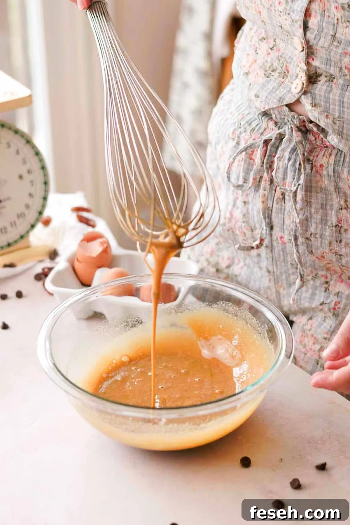 eggs and sugar whisked in a glass bowl
