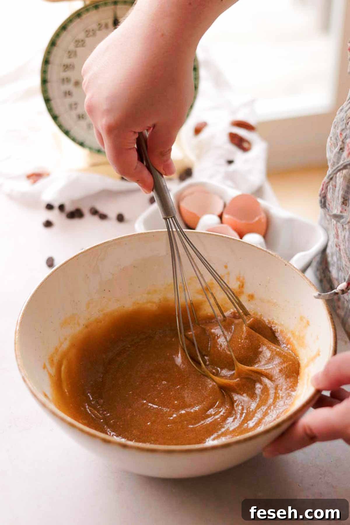 pecan toppings whisked into a gooey light brown mix