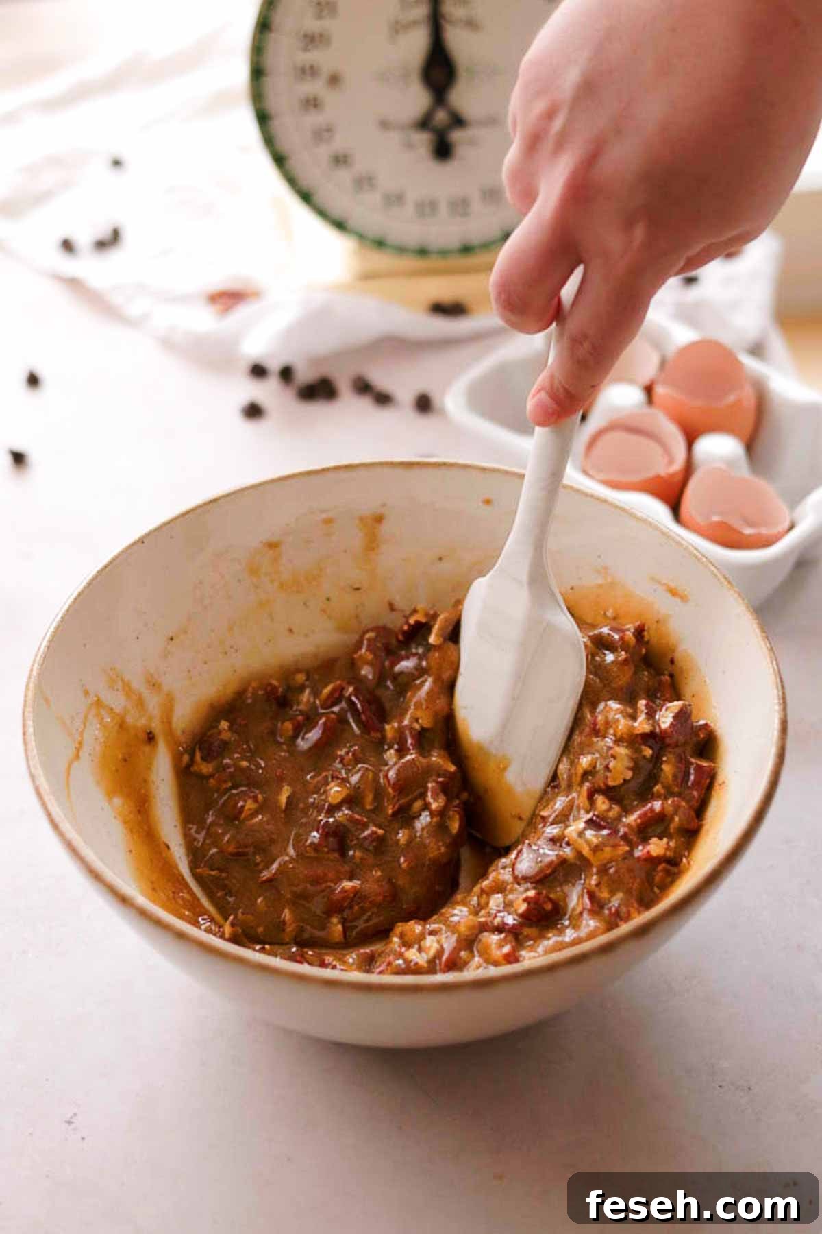 mixing pecans into pecan pie butter