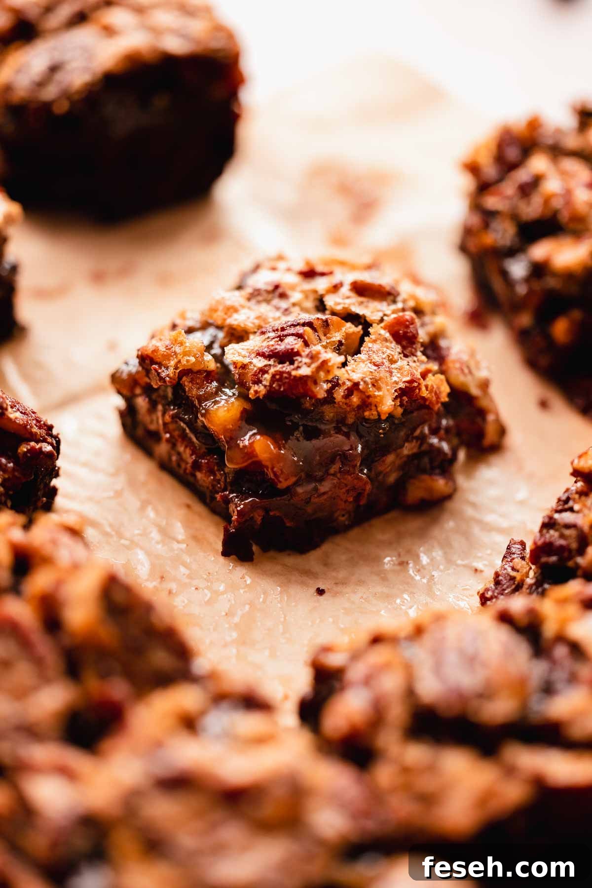 separate brownie square with a gooey layer inside and crusted pecan top