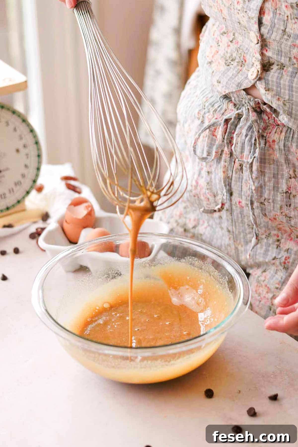 eggs and sugar whisked in a glass bowl