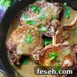 Pork Chops & Mustard Cream Sauce in a cast iron skillet