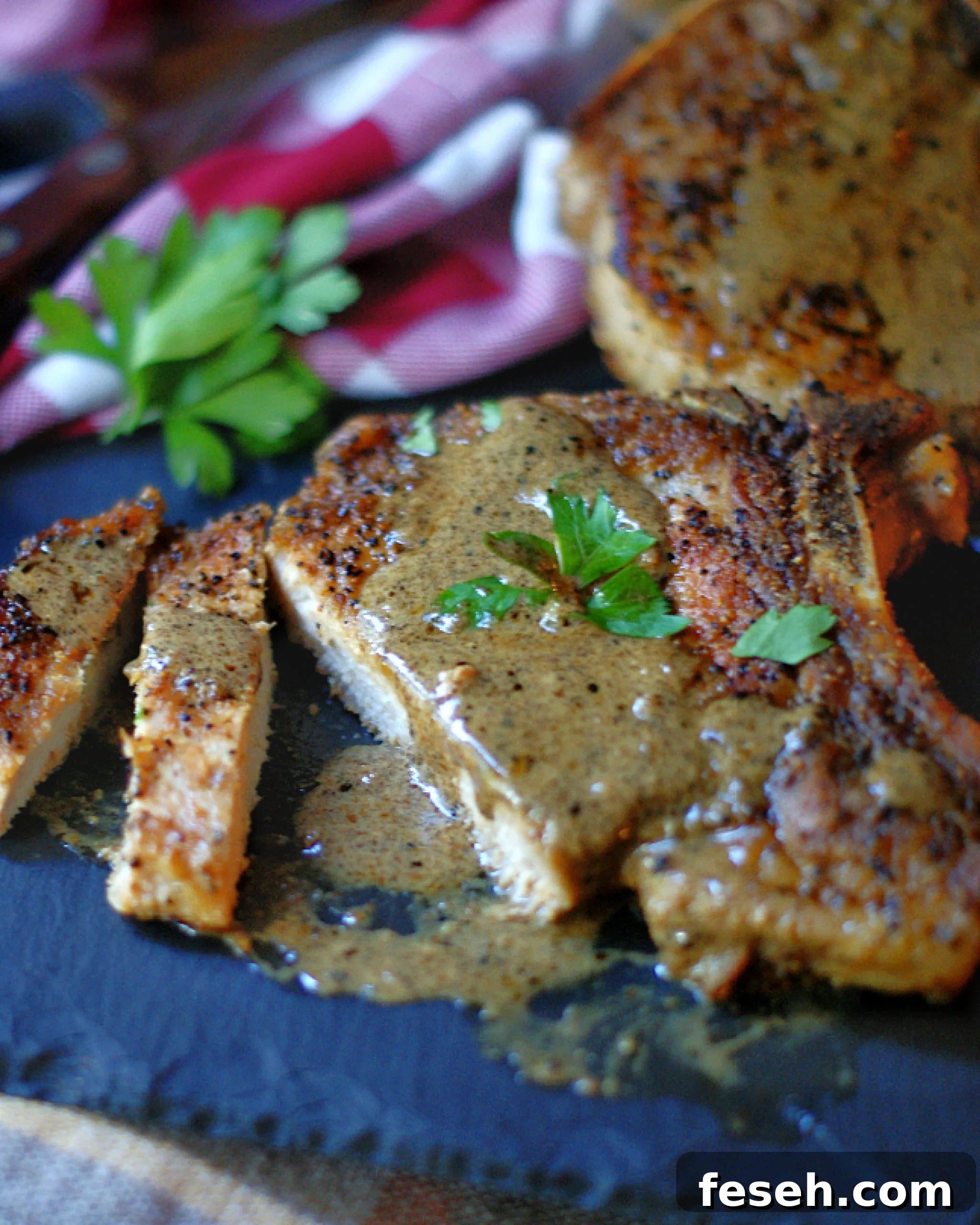 Skillet Pork Chops & Mustard Cream Sauce Sliced on a cutting board