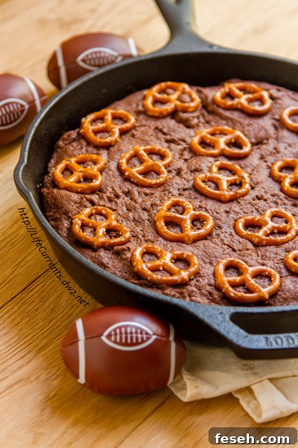 Skillet brownies with pretzel crust in a skillet.