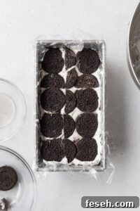 Chocolate cookies on top of cream to build an icebox cake.