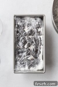 Ice box cake wrapped in plastic, ready to be chilled.