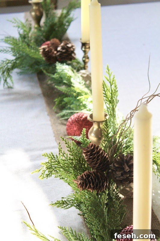 garland with ornaments and candles on table