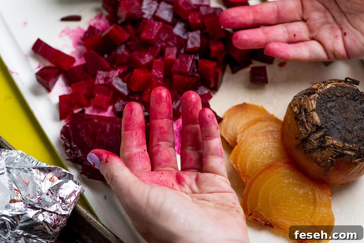 Woman's red-stained hands from cutting roasted beets.
