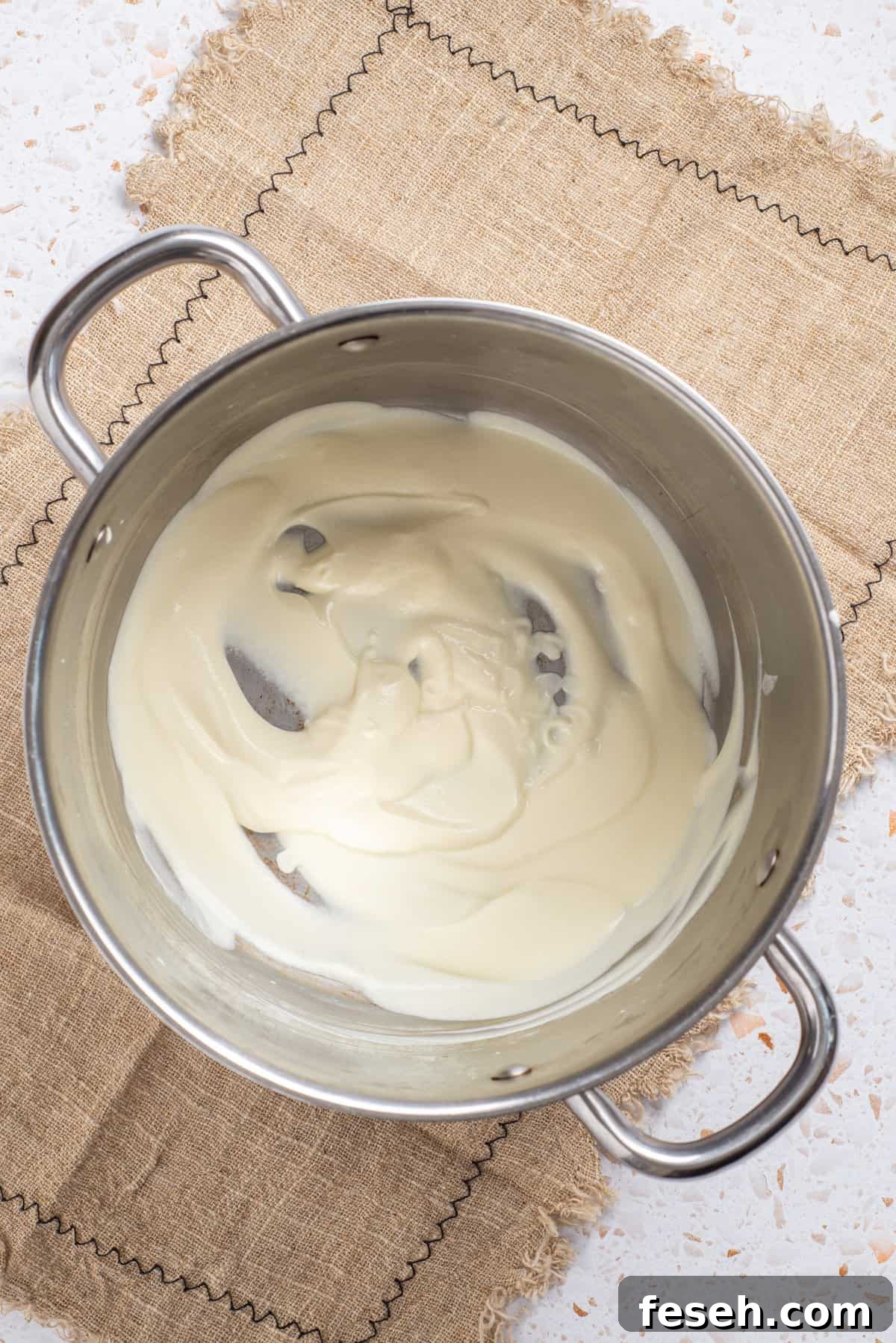 An image of melted cream cheese in a saucepan.