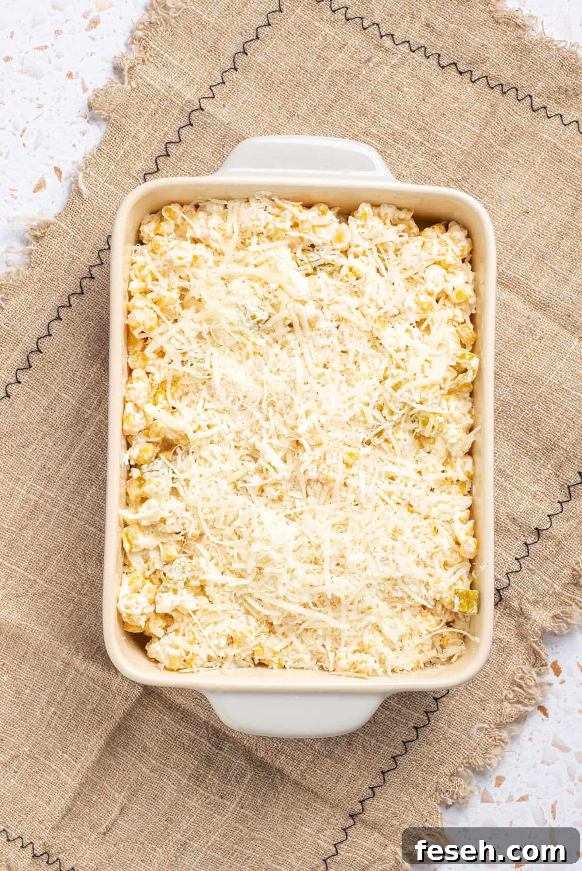 An image of corn casserole in a baking dish before baking