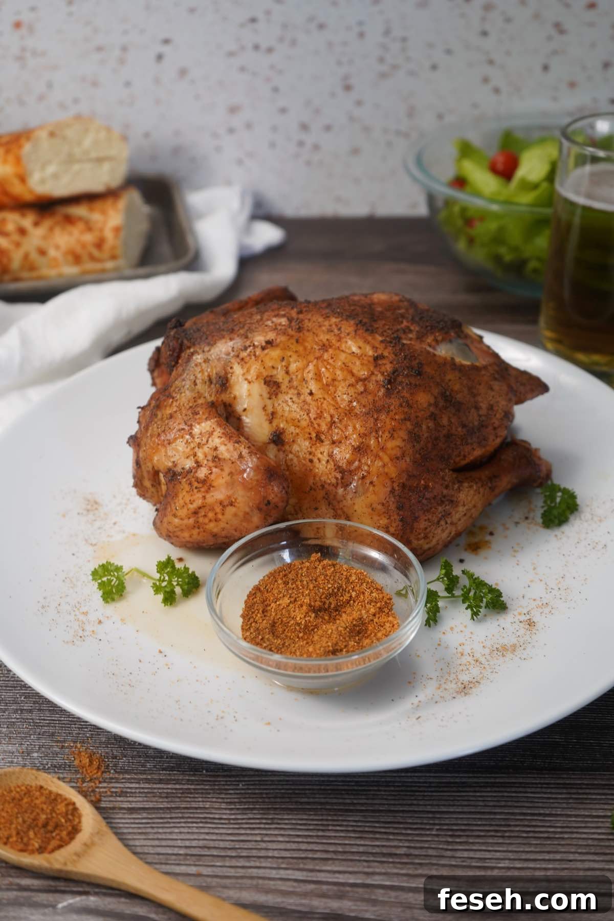 Whole chicken with seasonings on platter